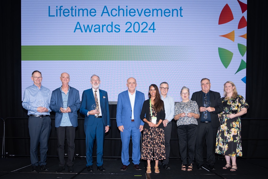 Image of all 2024 Lifetime Achievement Awards winner or proxy collectors on stage with Commissioner Ivan Frkovic